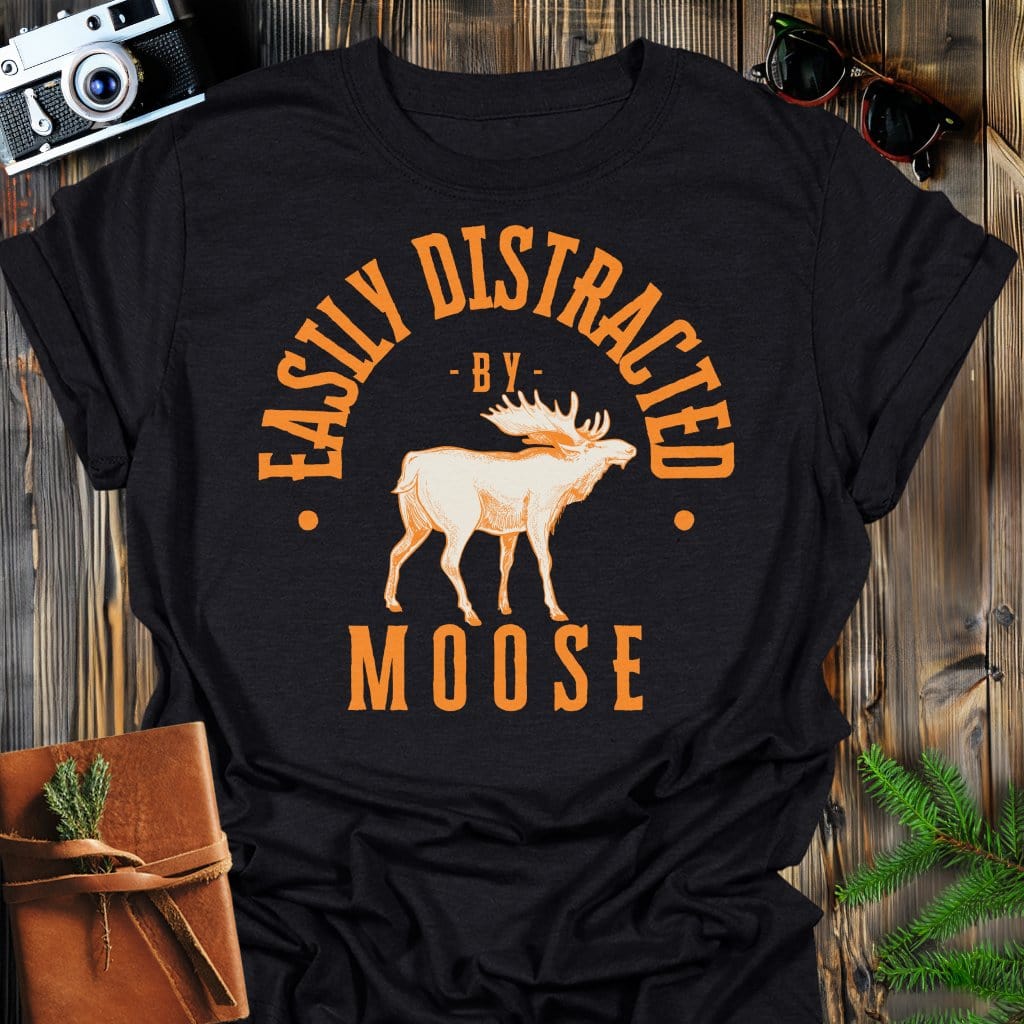 Distracted by Moose T-Shirt In S / Black Lightweight adventure tee for outdoor lovers Perfect for hiking camping or road trips Made from soft breathable cotton for all-day comfort Ideal for nature lovers and adventurers FAYO Threads outdoor apparel remember Fun Awaits You Outside
