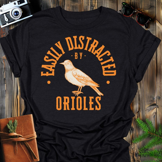 Distracted by Orioles T-Shirt In S / Black Lightweight adventure tee for outdoor lovers Perfect for hiking camping or road trips Made from soft breathable cotton for all-day comfort Ideal for nature lovers and adventurers FAYO Threads outdoor apparel remember Fun Awaits You Outside