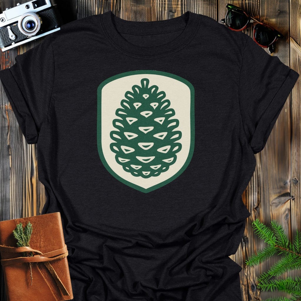 Pinecone Badge T-Shirt In S / Black Lightweight adventure tee for outdoor lovers Perfect for hiking camping or road trips Made from soft breathable cotton for all-day comfort Ideal for nature lovers and adventurers FAYO Threads outdoor apparel remember Fun Awaits You Outside