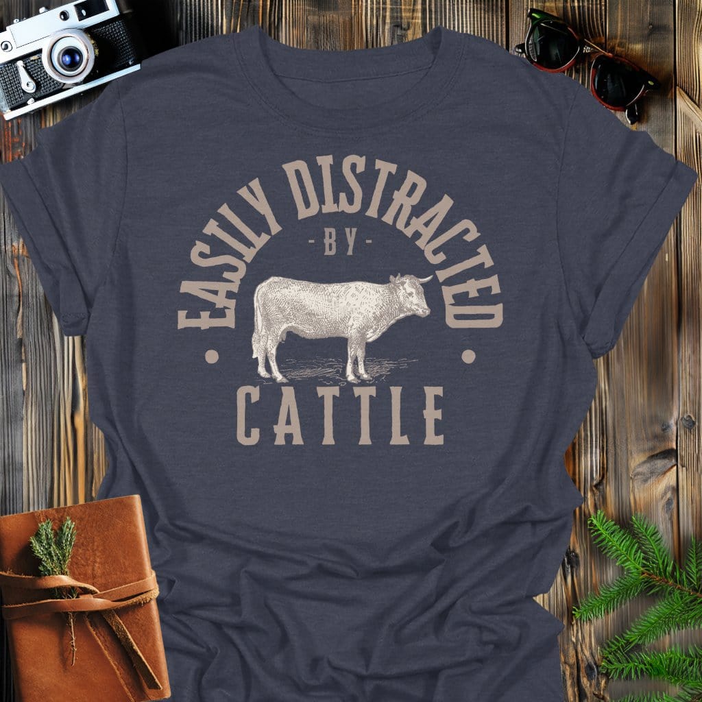 Distracted by Cattle T-Shirt In S / Dark Heather Lightweight adventure tee for outdoor lovers Perfect for hiking camping or road trips Made from soft breathable cotton for all-day comfort Ideal for nature lovers and adventurers FAYO Threads outdoor apparel remember Fun Awaits You Outside