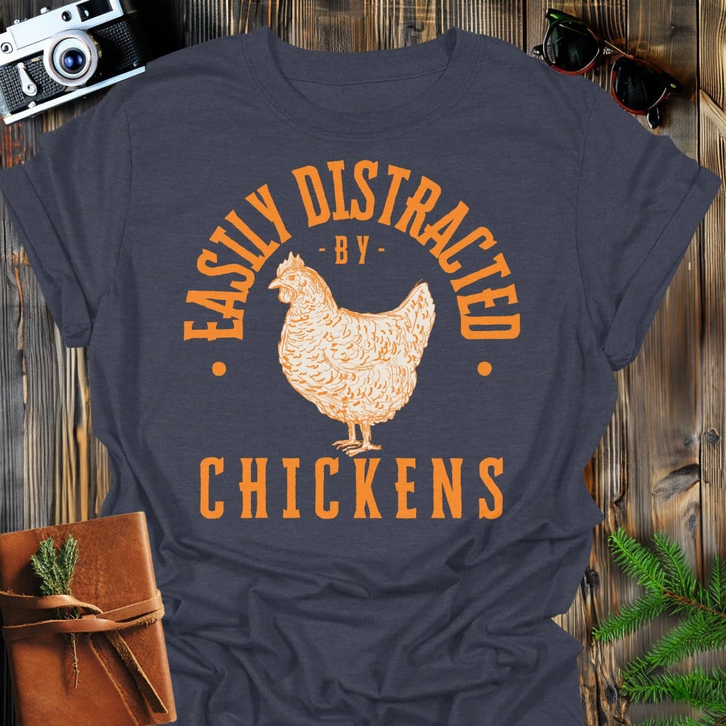 Distracted by Chickens T-Shirt In S / Dark Heather Lightweight adventure tee for outdoor lovers Perfect for hiking camping or road trips Made from soft breathable cotton for all-day comfort Ideal for nature lovers and adventurers FAYO Threads outdoor apparel remember Fun Awaits You Outside