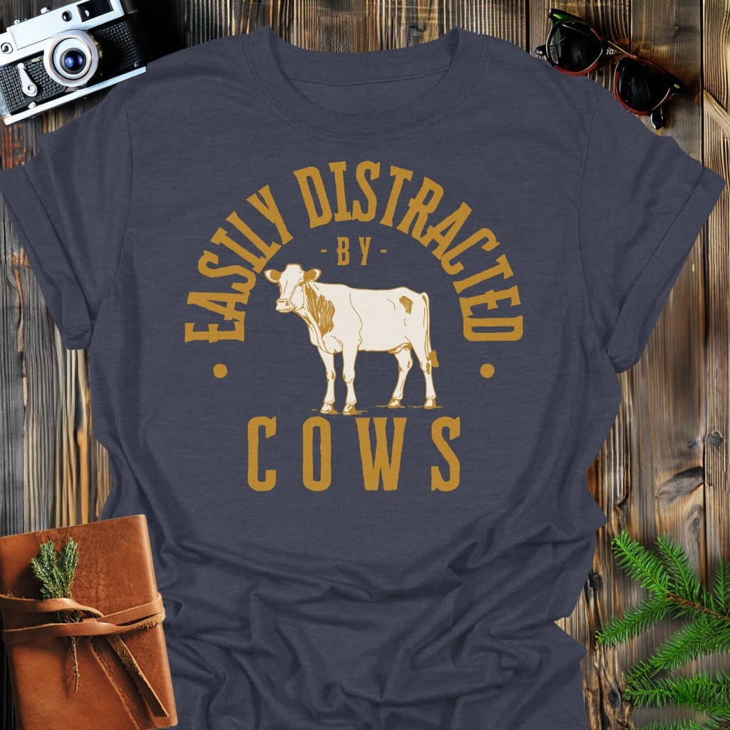 Distracted by Cows T-Shirt In S / Dark Heather Lightweight adventure tee for outdoor lovers Perfect for hiking camping or road trips Made from soft breathable cotton for all-day comfort Ideal for nature lovers and adventurers FAYO Threads outdoor apparel remember Fun Awaits You Outside