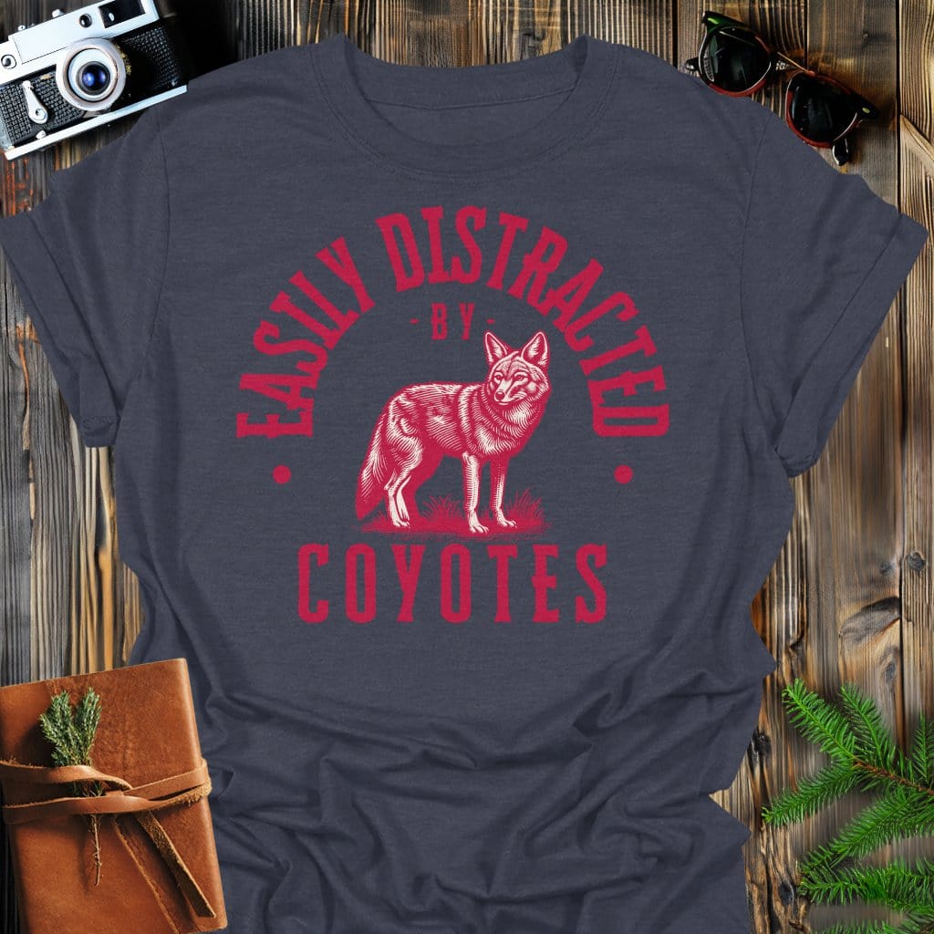 Distracted by Coyotes T-Shirt In S / Dark Heather Lightweight adventure tee for outdoor lovers Perfect for hiking camping or road trips Made from soft breathable cotton for all-day comfort Ideal for nature lovers and adventurers FAYO Threads outdoor apparel remember Fun Awaits You Outside