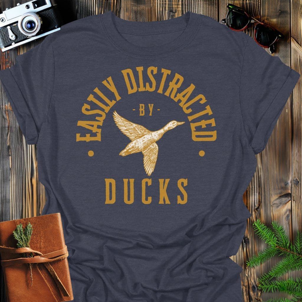 Distracted by Ducks T-Shirt In S / Dark Heather Lightweight adventure tee for outdoor lovers Perfect for hiking camping or road trips Made from soft breathable cotton for all-day comfort Ideal for nature lovers and adventurers FAYO Threads outdoor apparel remember Fun Awaits You Outside