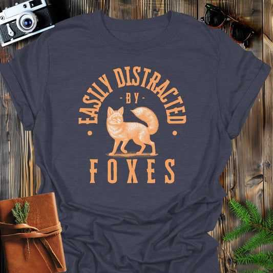Distracted by Foxes T-Shirt In S / Dark Heather Lightweight adventure tee for outdoor lovers Perfect for hiking camping or road trips Made from soft breathable cotton for all-day comfort Ideal for nature lovers and adventurers FAYO Threads outdoor apparel remember Fun Awaits You Outside