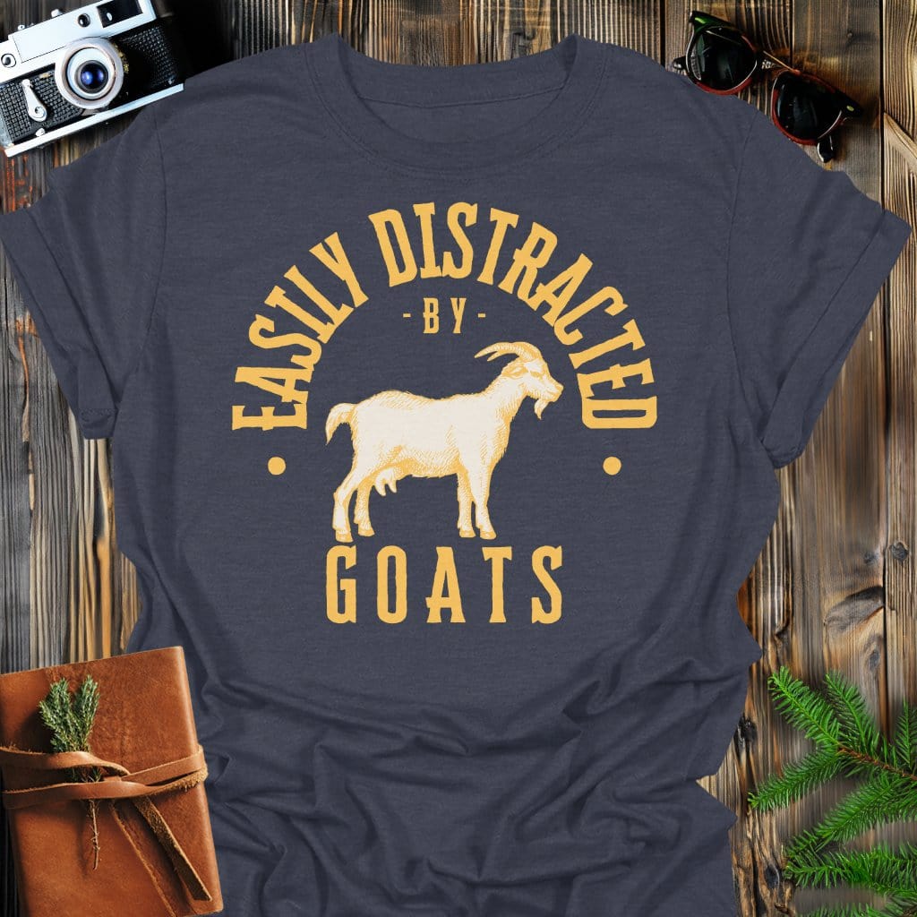 Distracted by Goats T-Shirt In S / Dark Heather Lightweight adventure tee for outdoor lovers Perfect for hiking camping or road trips Made from soft breathable cotton for all-day comfort Ideal for nature lovers and adventurers FAYO Threads outdoor apparel remember Fun Awaits You Outside