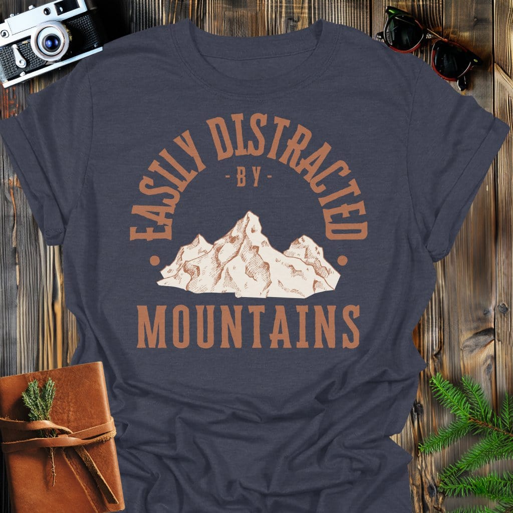Distracted by Mountains T-Shirt In S / Dark Heather Lightweight adventure tee for outdoor lovers Perfect for hiking camping or road trips Made from soft breathable cotton for all-day comfort Ideal for nature lovers and adventurers FAYO Threads outdoor apparel remember Fun Awaits You Outside