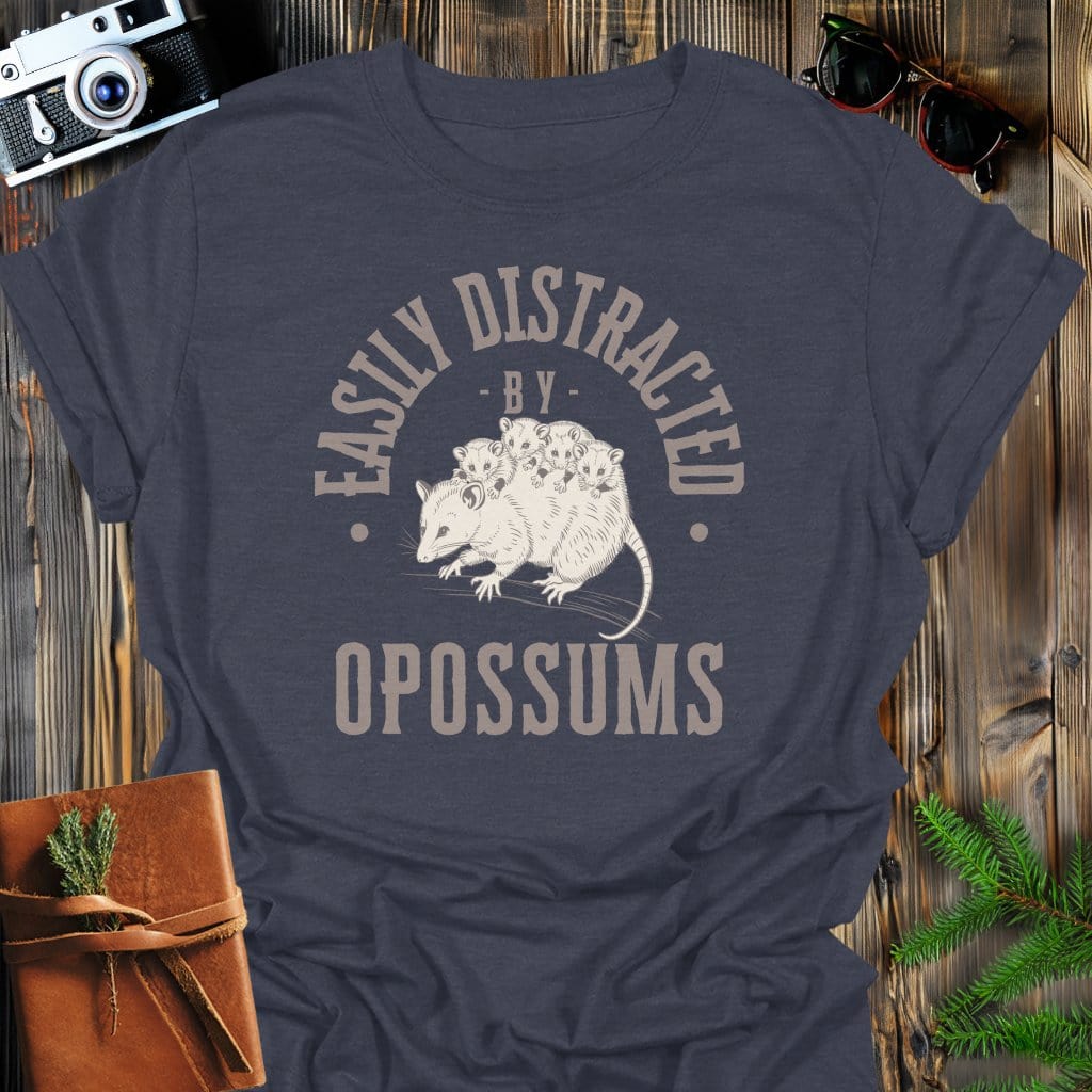 Distracted by Opossums T-Shirt In S / Dark Heather Lightweight adventure tee for outdoor lovers Perfect for hiking camping or road trips Made from soft breathable cotton for all-day comfort Ideal for nature lovers and adventurers FAYO Threads outdoor apparel remember Fun Awaits You Outside