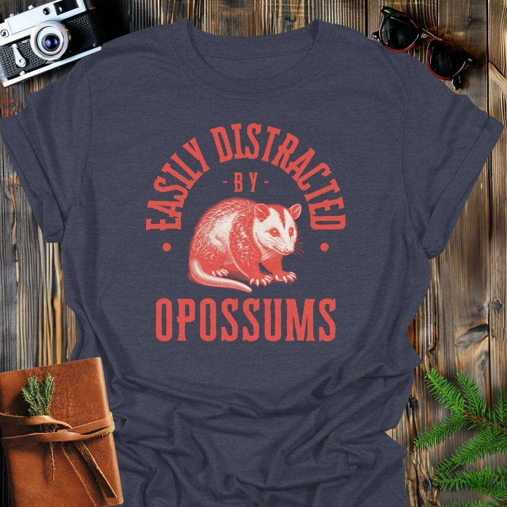Distracted by Opossums T-Shirt In S / Dark Heather Lightweight adventure tee for outdoor lovers Perfect for hiking camping or road trips Made from soft breathable cotton for all-day comfort Ideal for nature lovers and adventurers FAYO Threads outdoor apparel remember Fun Awaits You Outside