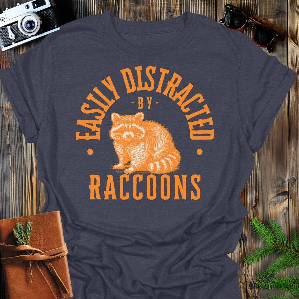 Distracted by Raccoons T-Shirt In S / Dark Heather Lightweight adventure tee for outdoor lovers Perfect for hiking camping or road trips Made from soft breathable cotton for all-day comfort Ideal for nature lovers and adventurers FAYO Threads outdoor apparel remember Fun Awaits You Outside