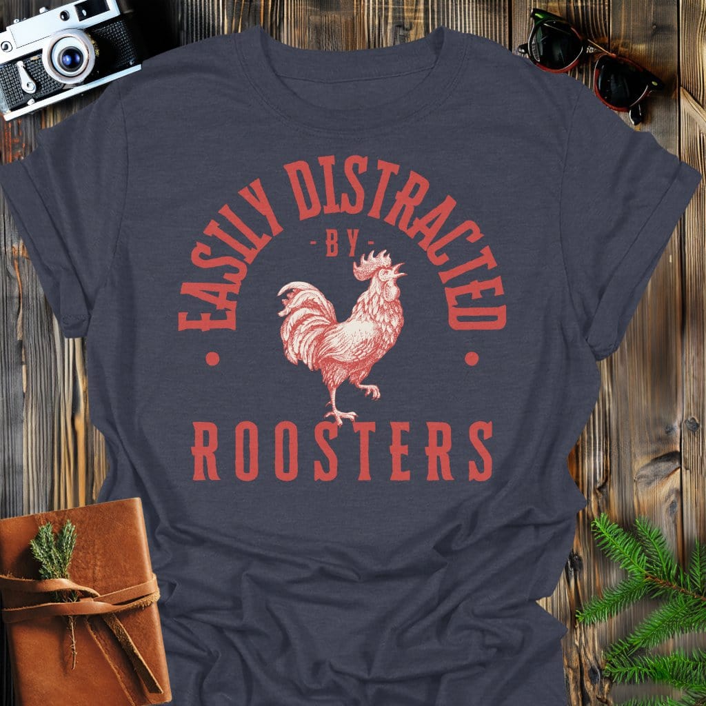 Distracted by Roosters T-Shirt In S / Dark Heather Lightweight adventure tee for outdoor lovers Perfect for hiking camping or road trips Made from soft breathable cotton for all-day comfort Ideal for nature lovers and adventurers FAYO Threads outdoor apparel remember Fun Awaits You Outside