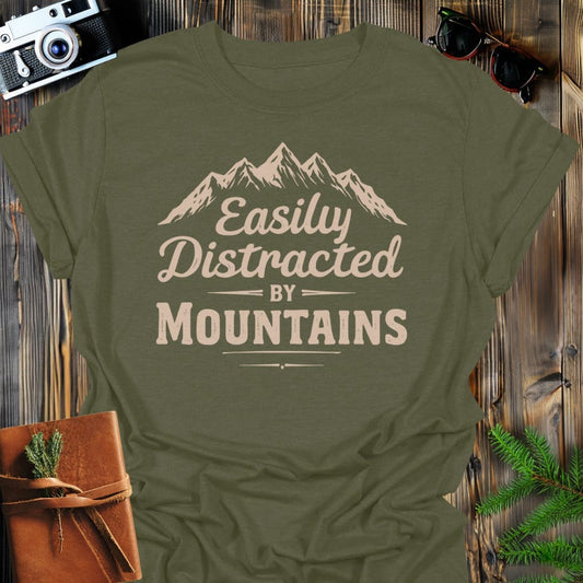 Distracted by Mountains T-Shirt In S / Military Green Lightweight adventure tee for outdoor lovers Perfect for hiking camping or road trips Made from soft breathable cotton for all-day comfort Ideal for nature lovers and adventurers FAYO Threads outdoor apparel remember Fun Awaits You Outside
