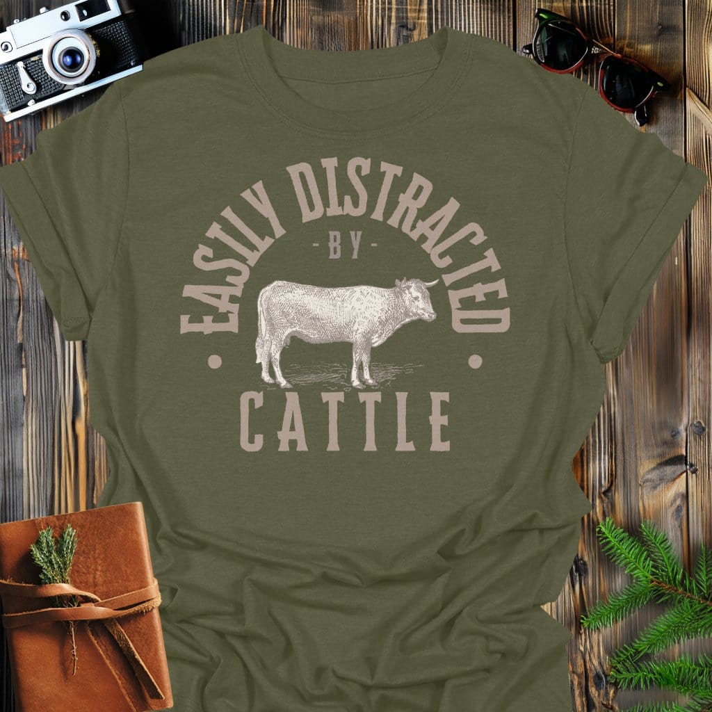 Distracted by Cattle T-Shirt In S / Military Green Lightweight adventure tee for outdoor lovers Perfect for hiking camping or road trips Made from soft breathable cotton for all-day comfort Ideal for nature lovers and adventurers FAYO Threads outdoor apparel remember Fun Awaits You Outside