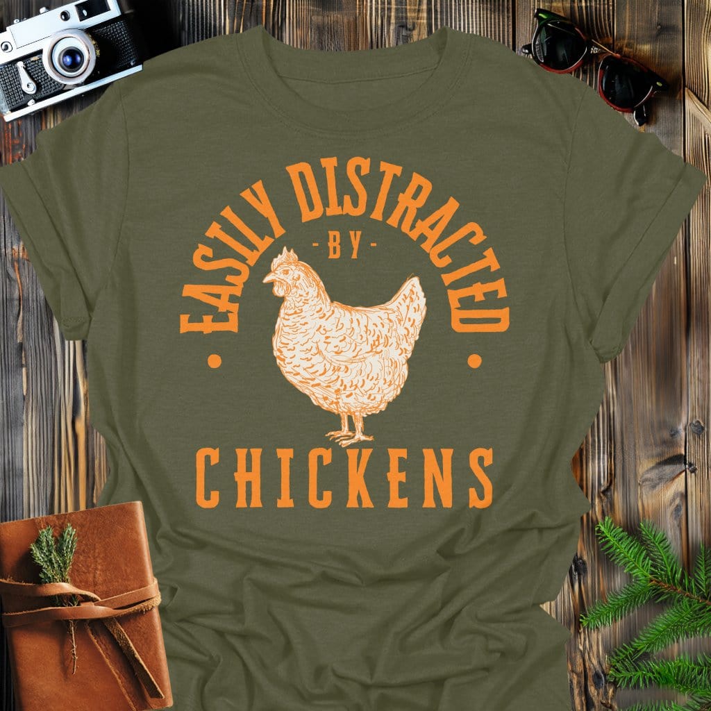 Distracted by Chickens T-Shirt In S / Military Green Lightweight adventure tee for outdoor lovers Perfect for hiking camping or road trips Made from soft breathable cotton for all-day comfort Ideal for nature lovers and adventurers FAYO Threads outdoor apparel remember Fun Awaits You Outside