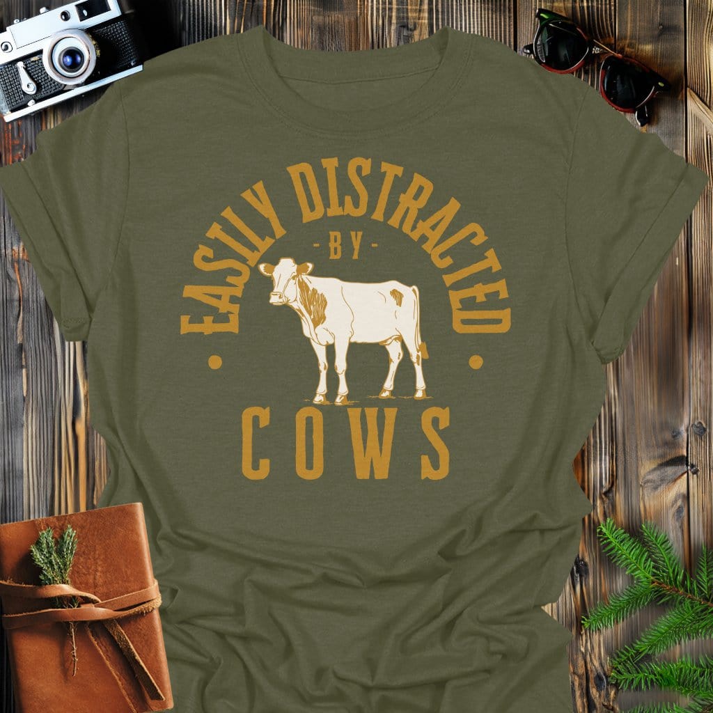 Distracted by Cows T-Shirt In S / Military Green Lightweight adventure tee for outdoor lovers Perfect for hiking camping or road trips Made from soft breathable cotton for all-day comfort Ideal for nature lovers and adventurers FAYO Threads outdoor apparel remember Fun Awaits You Outside