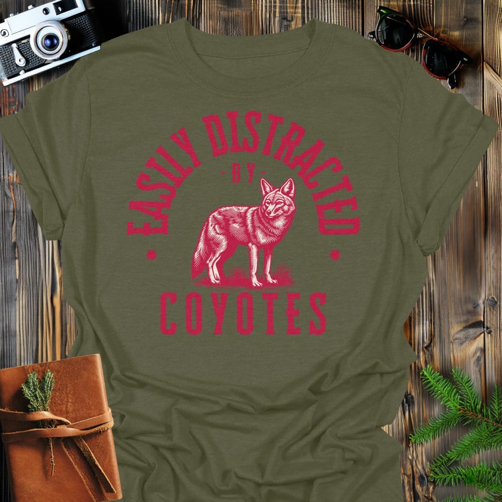 Distracted by Coyotes T-Shirt In S / Military Green Lightweight adventure tee for outdoor lovers Perfect for hiking camping or road trips Made from soft breathable cotton for all-day comfort Ideal for nature lovers and adventurers FAYO Threads outdoor apparel remember Fun Awaits You Outside
