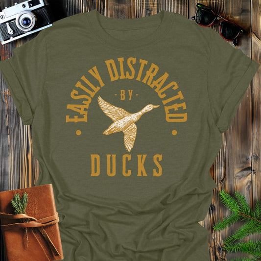 Distracted by Ducks T-Shirt In S / Military Green Lightweight adventure tee for outdoor lovers Perfect for hiking camping or road trips Made from soft breathable cotton for all-day comfort Ideal for nature lovers and adventurers FAYO Threads outdoor apparel remember Fun Awaits You Outside