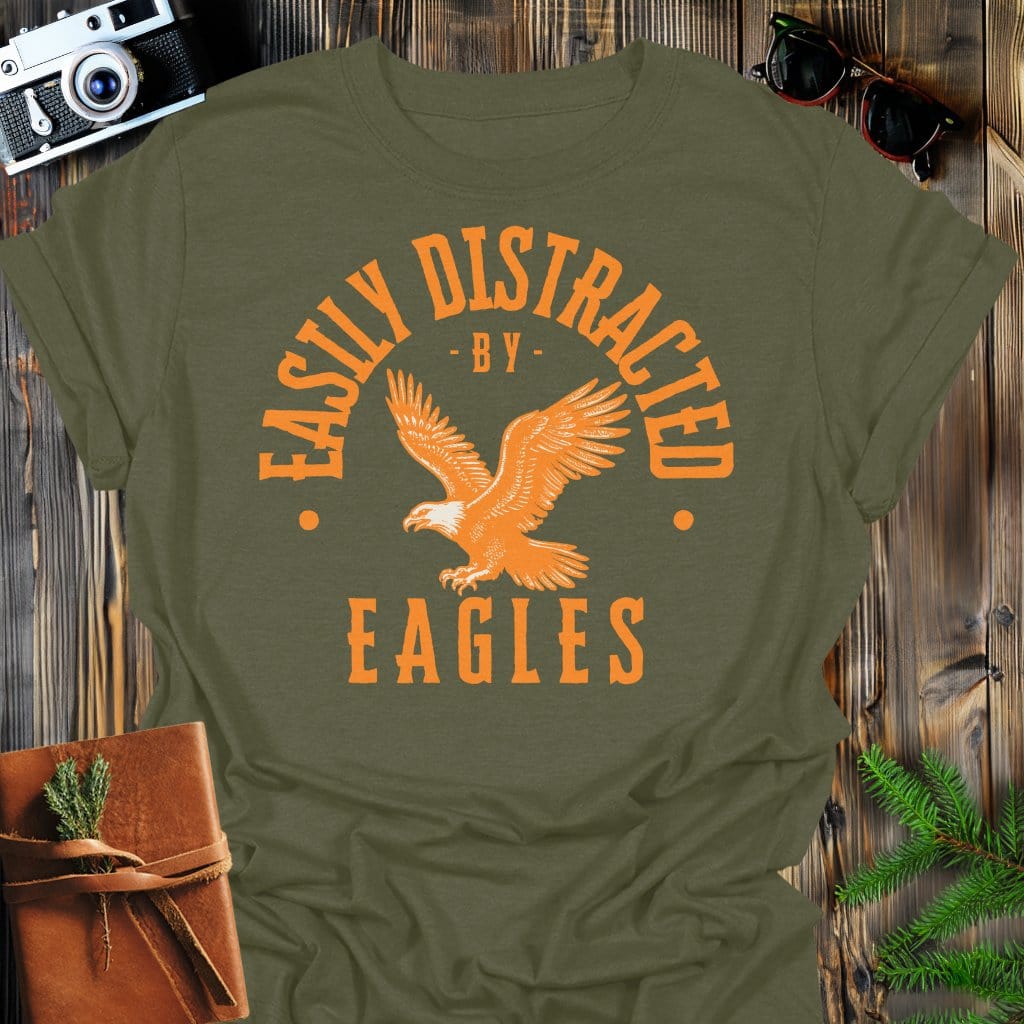 Distracted by Eagles T-Shirt In S / Military Green Lightweight adventure tee for outdoor lovers Perfect for hiking camping or road trips Made from soft breathable cotton for all-day comfort Ideal for nature lovers and adventurers FAYO Threads outdoor apparel remember Fun Awaits You Outside