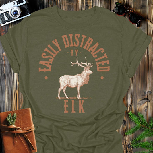 Distracted by Elk T-Shirt In S / Military Green Lightweight adventure tee for outdoor lovers Perfect for hiking camping or road trips Made from soft breathable cotton for all-day comfort Ideal for nature lovers and adventurers FAYO Threads outdoor apparel remember Fun Awaits You Outside