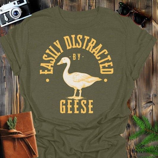 Distracted by Geese T-Shirt In S / Military Green Lightweight adventure tee for outdoor lovers Perfect for hiking camping or road trips Made from soft breathable cotton for all-day comfort Ideal for nature lovers and adventurers FAYO Threads outdoor apparel remember Fun Awaits You Outside