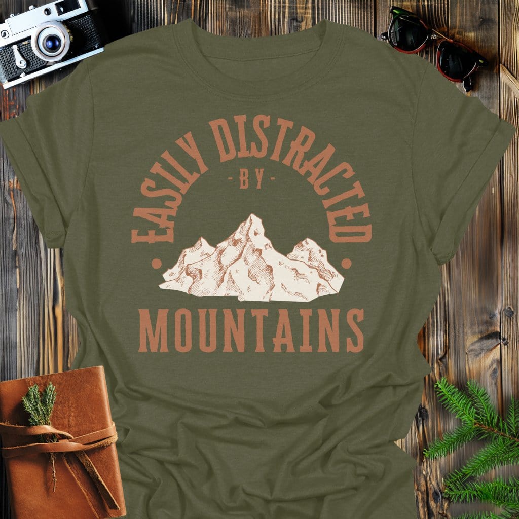 Distracted by Mountains T-Shirt In S / Military Green Lightweight adventure tee for outdoor lovers Perfect for hiking camping or road trips Made from soft breathable cotton for all-day comfort Ideal for nature lovers and adventurers FAYO Threads outdoor apparel remember Fun Awaits You Outside