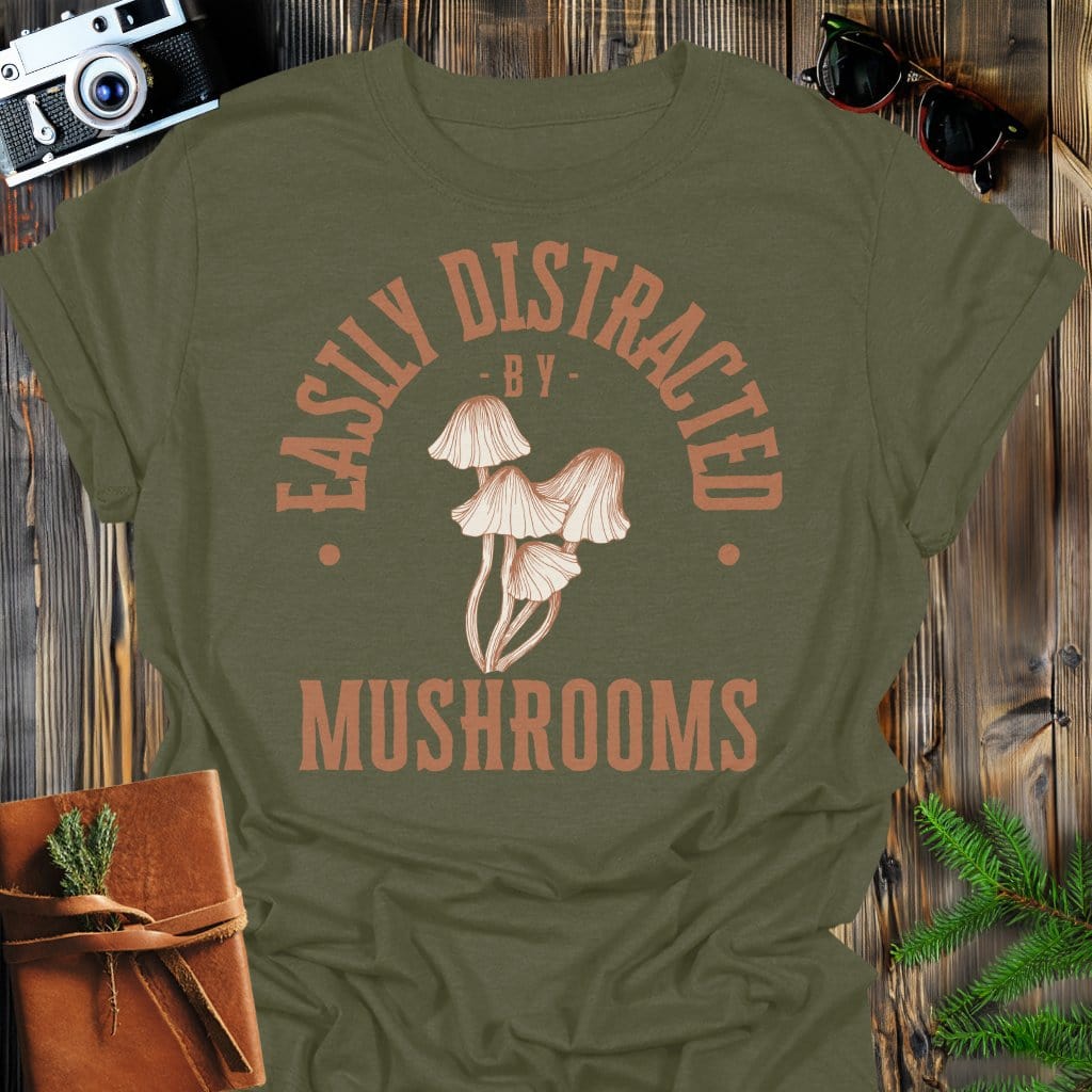 Distracted by Mushrooms T-Shirt In S / Military Green Lightweight adventure tee for outdoor lovers Perfect for hiking camping or road trips Made from soft breathable cotton for all-day comfort Ideal for nature lovers and adventurers FAYO Threads outdoor apparel remember Fun Awaits You Outside