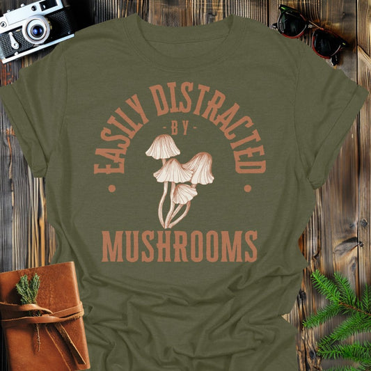 Distracted by Mushrooms T-Shirt In S / Military Green Lightweight adventure tee for outdoor lovers Perfect for hiking camping or road trips Made from soft breathable cotton for all-day comfort Ideal for nature lovers and adventurers FAYO Threads outdoor apparel remember Fun Awaits You Outside