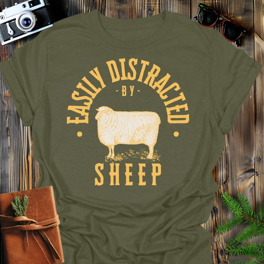 Distracted by Sheep T-Shirt In S / Military Green Lightweight adventure tee for outdoor lovers Perfect for hiking camping or road trips Made from soft breathable cotton for all-day comfort Ideal for nature lovers and adventurers FAYO Threads outdoor apparel remember Fun Awaits You Outside