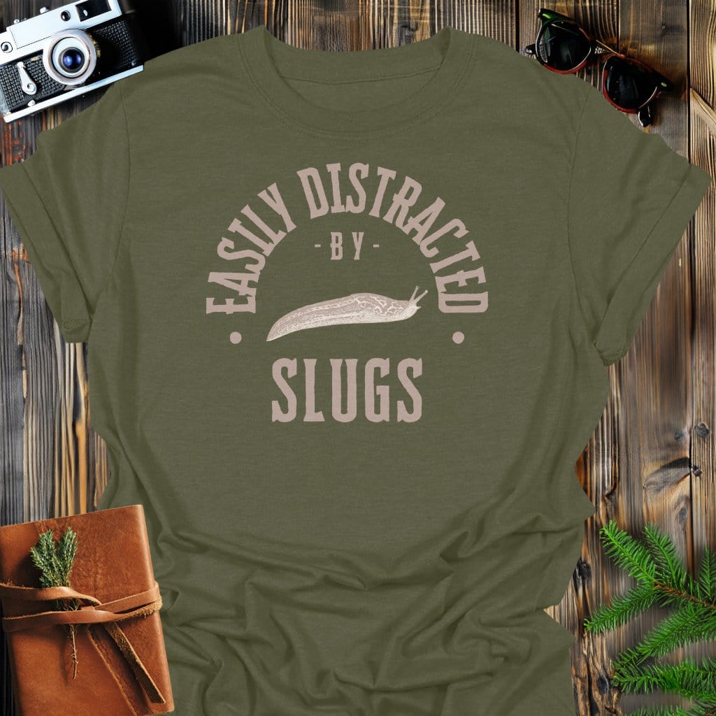 Distracted By Slugs T-Shirt In S / Military Green Lightweight adventure tee for outdoor lovers Perfect for hiking camping or road trips Made from soft breathable cotton for all-day comfort Ideal for nature lovers and adventurers FAYO Threads outdoor apparel remember Fun Awaits You Outside