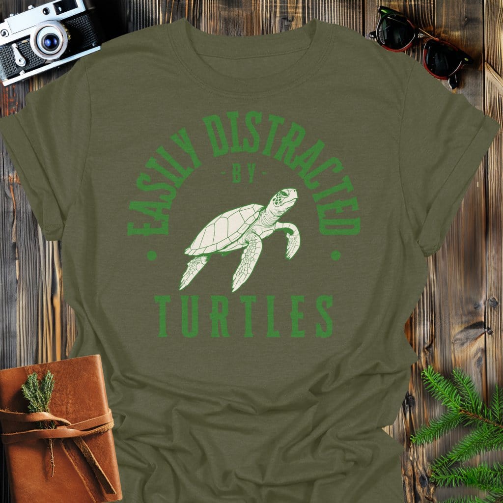 Distracted by Turtles T-Shirt In S / Military Green Lightweight adventure tee for outdoor lovers Perfect for hiking camping or road trips Made from soft breathable cotton for all-day comfort Ideal for nature lovers and adventurers FAYO Threads outdoor apparel remember Fun Awaits You Outside