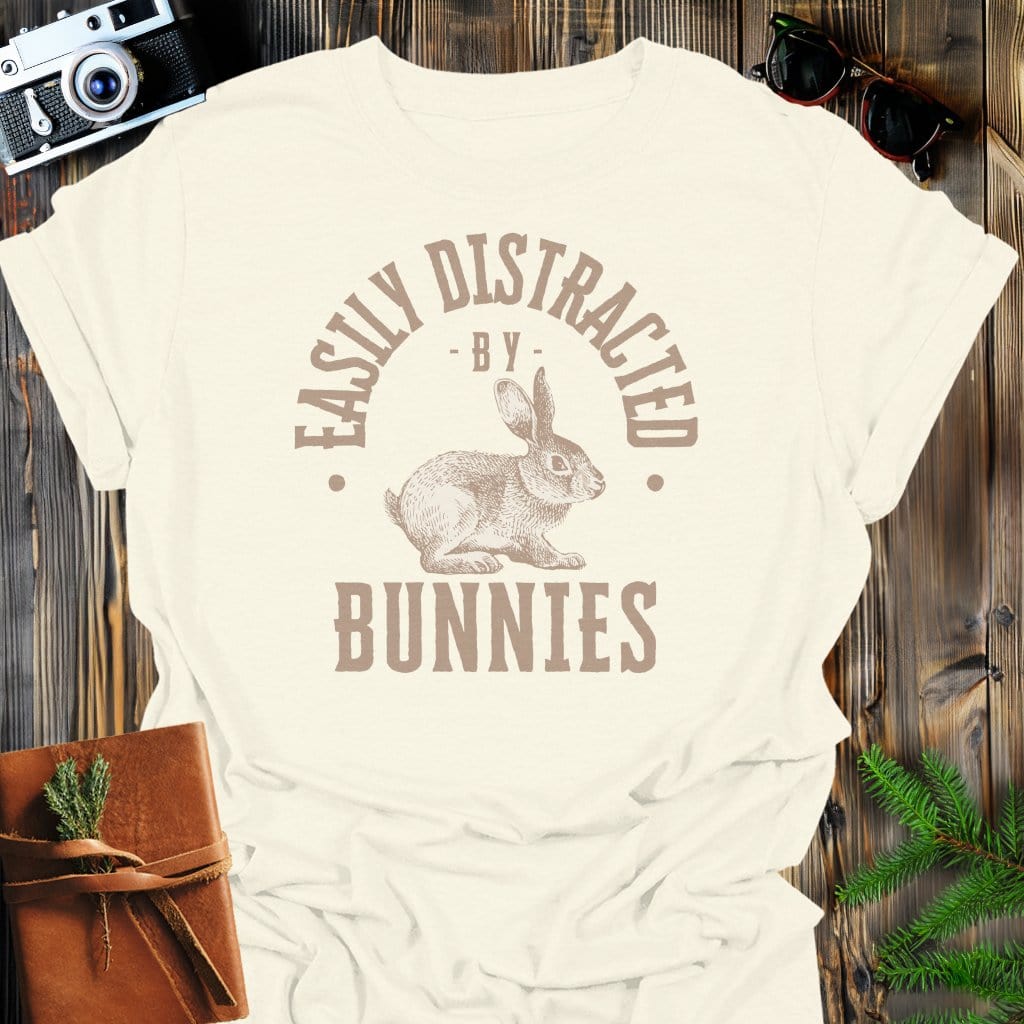 Distracted By Bunnies T-Shirt In S / Natural Lightweight adventure tee for outdoor lovers Perfect for hiking camping or road trips Made from soft breathable cotton for all-day comfort Ideal for nature lovers and adventurers FAYO Threads outdoor apparel remember Fun Awaits You Outside