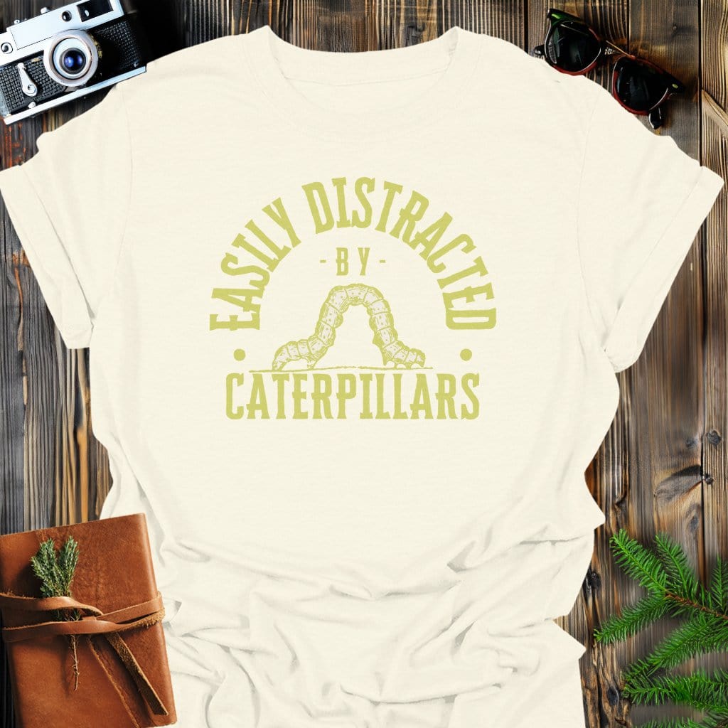 Distracted by Caterpillars T-Shirt In S / Natural Lightweight adventure tee for outdoor lovers Perfect for hiking camping or road trips Made from soft breathable cotton for all-day comfort Ideal for nature lovers and adventurers FAYO Threads outdoor apparel remember Fun Awaits You Outside