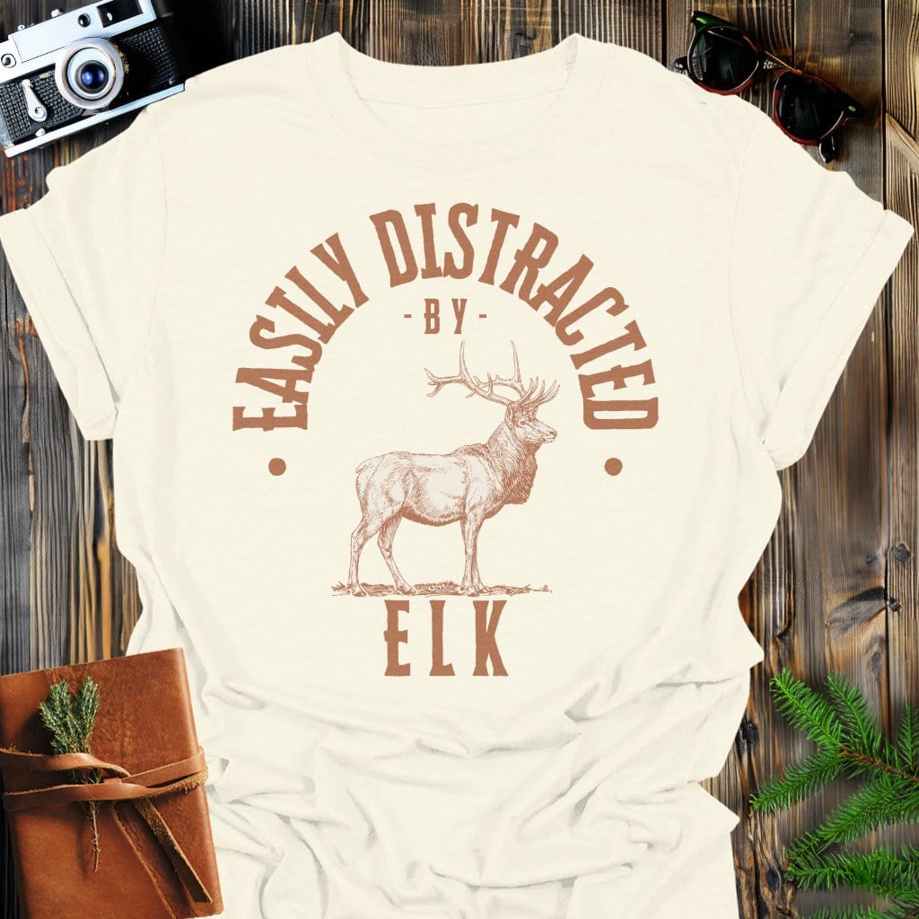 Distracted by Elk T-Shirt In S / Natural Lightweight adventure tee for outdoor lovers Perfect for hiking camping or road trips Made from soft breathable cotton for all-day comfort Ideal for nature lovers and adventurers FAYO Threads outdoor apparel remember Fun Awaits You Outside