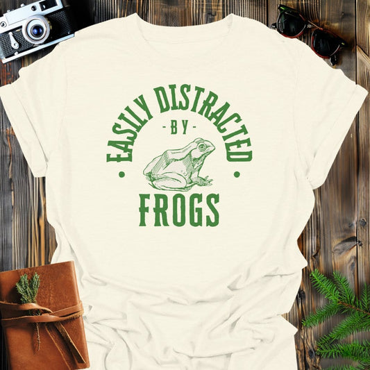 Distracted By Frogs T-Shirt In S / Natural Lightweight adventure tee for outdoor lovers Perfect for hiking camping or road trips Made from soft breathable cotton for all-day comfort Ideal for nature lovers and adventurers FAYO Threads outdoor apparel remember Fun Awaits You Outside