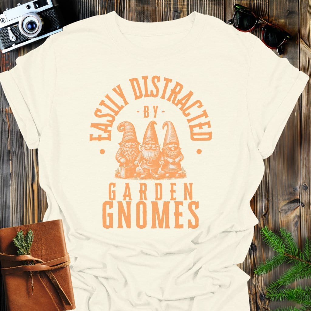 Distracted by Garden Gnomes T-Shirt In S / Natural Lightweight adventure tee for outdoor lovers Perfect for hiking camping or road trips Made from soft breathable cotton for all-day comfort Ideal for nature lovers and adventurers FAYO Threads outdoor apparel remember Fun Awaits You Outside