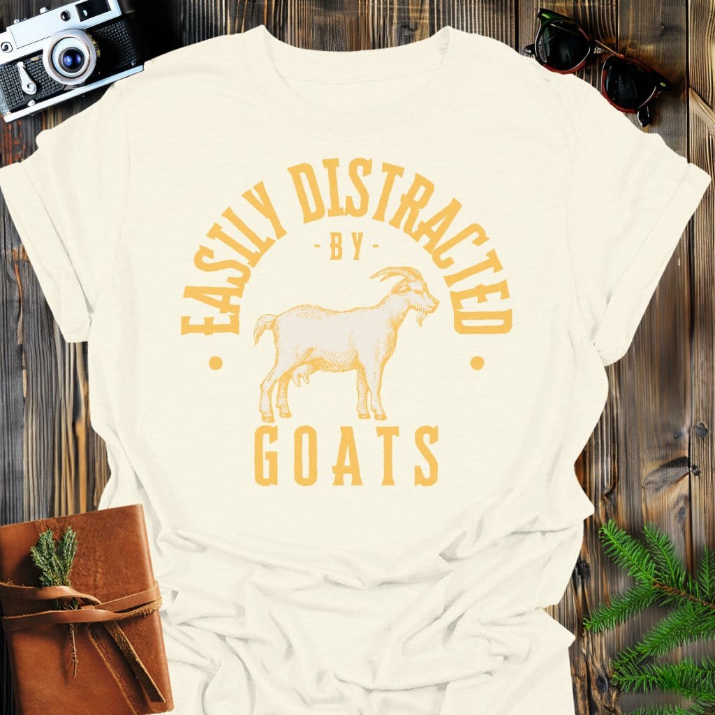 Distracted by Goats T-Shirt In S / Natural Lightweight adventure tee for outdoor lovers Perfect for hiking camping or road trips Made from soft breathable cotton for all-day comfort Ideal for nature lovers and adventurers FAYO Threads outdoor apparel remember Fun Awaits You Outside
