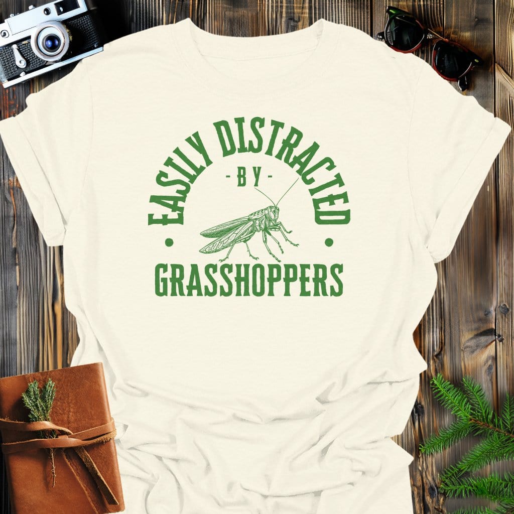 Distracted By Grasshoppers T-Shirt In S / Natural Lightweight adventure tee for outdoor lovers Perfect for hiking camping or road trips Made from soft breathable cotton for all-day comfort Ideal for nature lovers and adventurers FAYO Threads outdoor apparel remember Fun Awaits You Outside