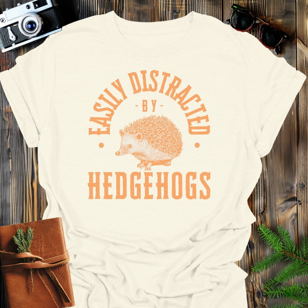 Distracted By Hedgehogs T-Shirt In S / Natural Lightweight adventure tee for outdoor lovers Perfect for hiking camping or road trips Made from soft breathable cotton for all-day comfort Ideal for nature lovers and adventurers FAYO Threads outdoor apparel remember Fun Awaits You Outside