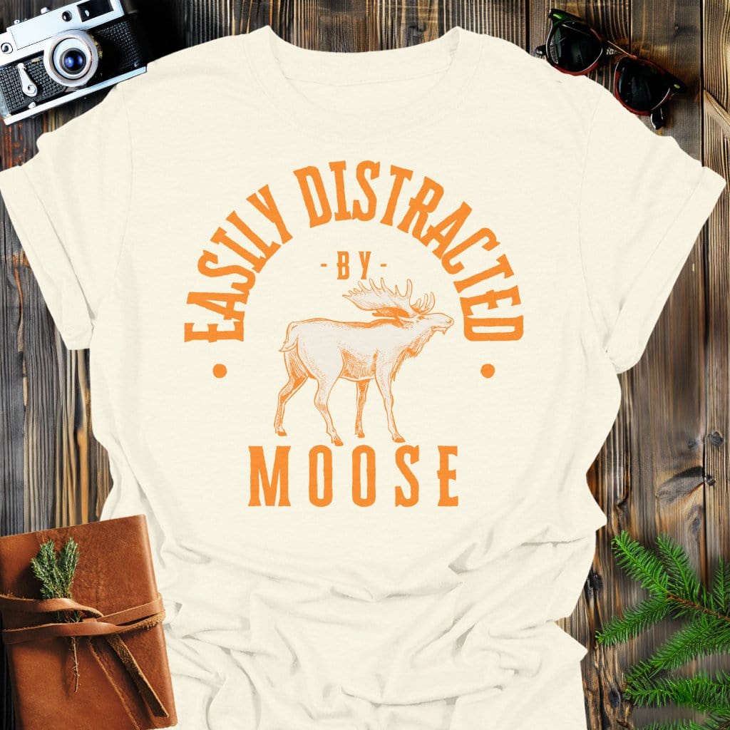 Distracted by Moose T-Shirt In S / Natural Lightweight adventure tee for outdoor lovers Perfect for hiking camping or road trips Made from soft breathable cotton for all-day comfort Ideal for nature lovers and adventurers FAYO Threads outdoor apparel remember Fun Awaits You Outside