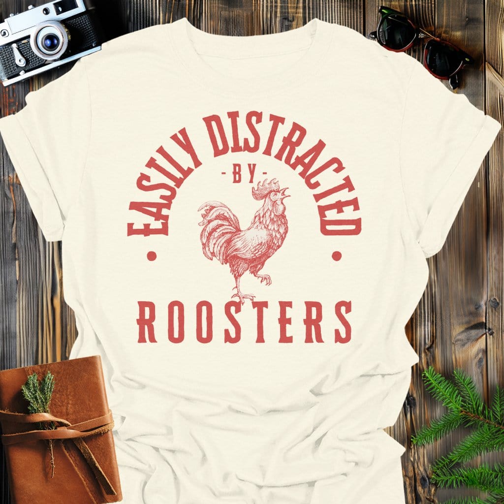 Distracted by Roosters T-Shirt In S / Natural Lightweight adventure tee for outdoor lovers Perfect for hiking camping or road trips Made from soft breathable cotton for all-day comfort Ideal for nature lovers and adventurers FAYO Threads outdoor apparel remember Fun Awaits You Outside