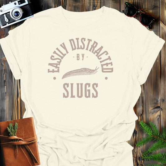 Distracted By Slugs T-Shirt In S / Natural Lightweight adventure tee for outdoor lovers Perfect for hiking camping or road trips Made from soft breathable cotton for all-day comfort Ideal for nature lovers and adventurers FAYO Threads outdoor apparel remember Fun Awaits You Outside