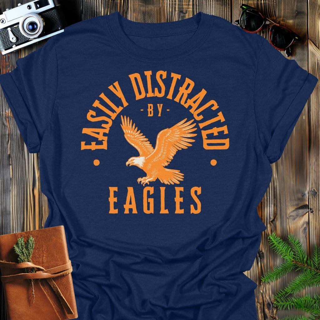 Distracted by Eagles T-Shirt In S / Navy Lightweight adventure tee for outdoor lovers Perfect for hiking camping or road trips Made from soft breathable cotton for all-day comfort Ideal for nature lovers and adventurers FAYO Threads outdoor apparel remember Fun Awaits You Outside