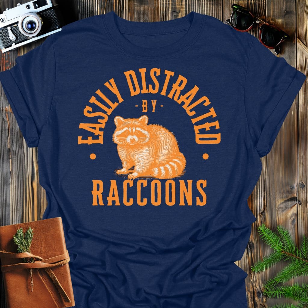 Distracted by Raccoons T-Shirt In S / Navy Lightweight adventure tee for outdoor lovers Perfect for hiking camping or road trips Made from soft breathable cotton for all-day comfort Ideal for nature lovers and adventurers FAYO Threads outdoor apparel remember Fun Awaits You Outside