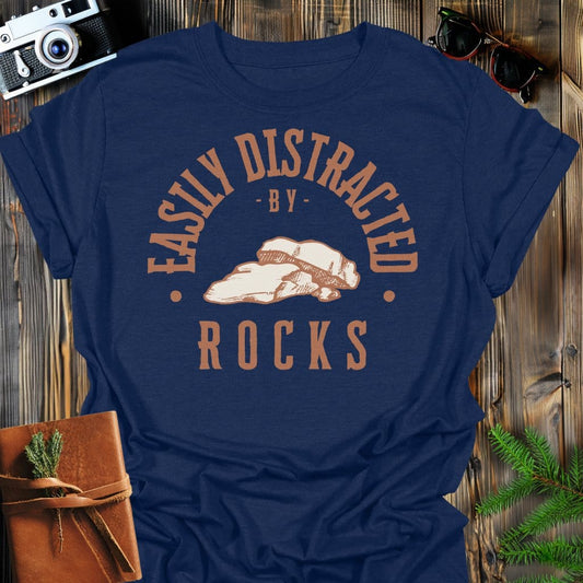 Distracted by Rocks T-Shirt In S / Navy Lightweight adventure tee for outdoor lovers Perfect for hiking camping or road trips Made from soft breathable cotton for all-day comfort Ideal for nature lovers and adventurers FAYO Threads outdoor apparel remember Fun Awaits You Outside