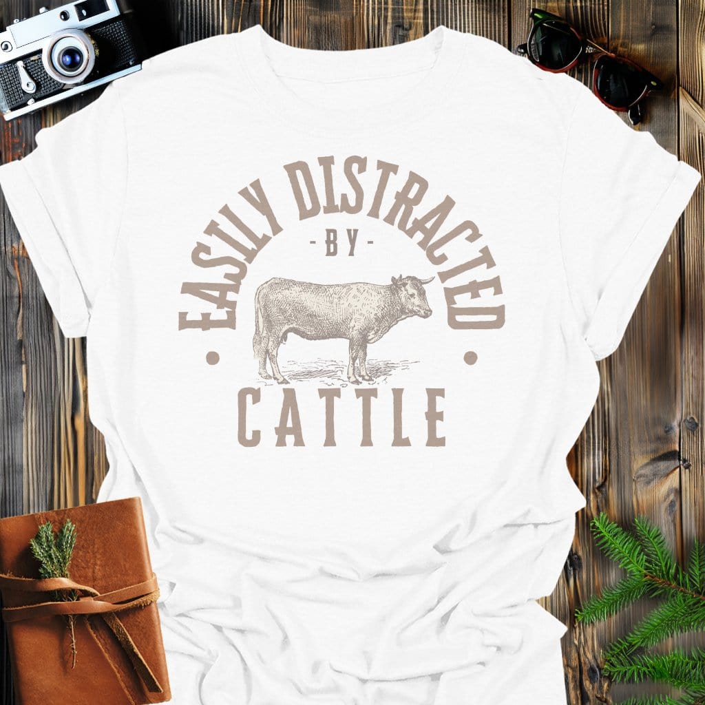Distracted by Cattle T-Shirt In S / White Lightweight adventure tee for outdoor lovers Perfect for hiking camping or road trips Made from soft breathable cotton for all-day comfort Ideal for nature lovers and adventurers FAYO Threads outdoor apparel remember Fun Awaits You Outside
