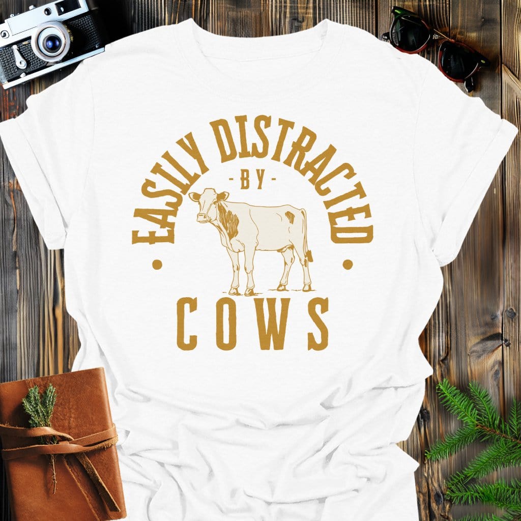 Distracted by Cows T-Shirt In S / White Lightweight adventure tee for outdoor lovers Perfect for hiking camping or road trips Made from soft breathable cotton for all-day comfort Ideal for nature lovers and adventurers FAYO Threads outdoor apparel remember Fun Awaits You Outside