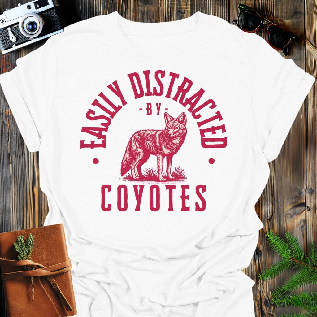 Distracted by Coyotes T-Shirt In S / White Lightweight adventure tee for outdoor lovers Perfect for hiking camping or road trips Made from soft breathable cotton for all-day comfort Ideal for nature lovers and adventurers FAYO Threads outdoor apparel remember Fun Awaits You Outside