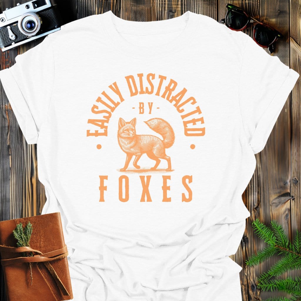 Distracted by Foxes T-Shirt In S / White Lightweight adventure tee for outdoor lovers Perfect for hiking camping or road trips Made from soft breathable cotton for all-day comfort Ideal for nature lovers and adventurers FAYO Threads outdoor apparel remember Fun Awaits You Outside