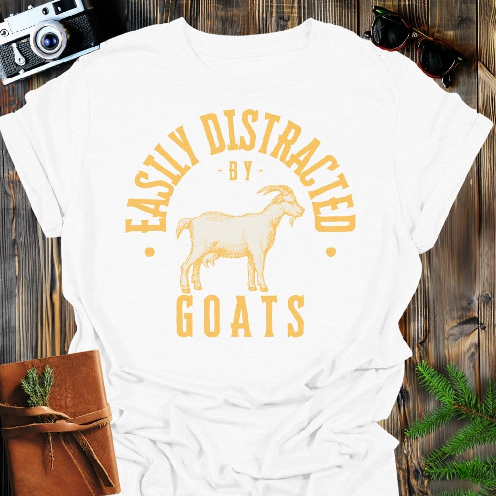 Distracted by Goats T-Shirt In S / White Lightweight adventure tee for outdoor lovers Perfect for hiking camping or road trips Made from soft breathable cotton for all-day comfort Ideal for nature lovers and adventurers FAYO Threads outdoor apparel remember Fun Awaits You Outside