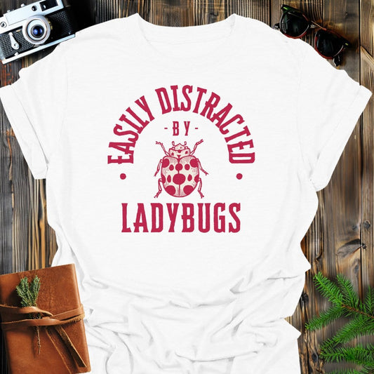 Distracted By Ladybugs T-Shirt In S / White Lightweight adventure tee for outdoor lovers Perfect for hiking camping or road trips Made from soft breathable cotton for all-day comfort Ideal for nature lovers and adventurers FAYO Threads outdoor apparel remember Fun Awaits You Outside